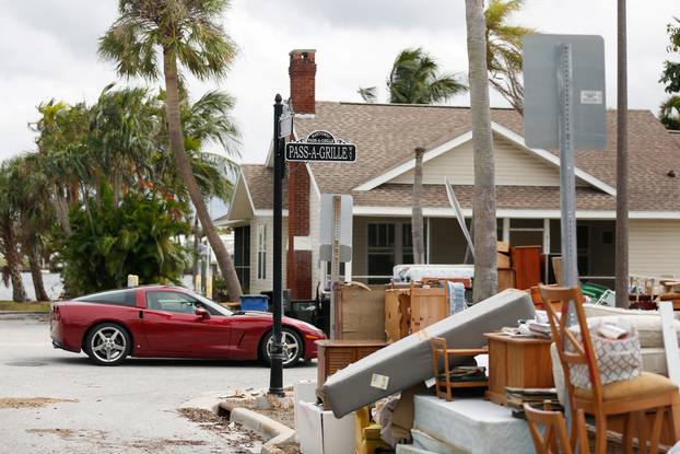 Debris from Hurricane Helene is seen on the roadside as residents evacuate before the arrival of Hurricane Milton, in St. Pete Beach, Florida