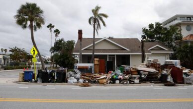 Debris from Hurricane Helene is seen on the roadside as residents evacuate before the arrival of Hurricane Milton, in St. Pete Beach, Florida