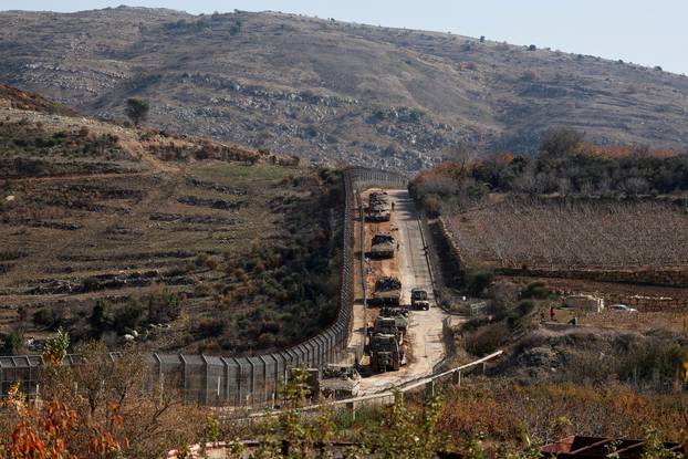 Israeli soldiers gather near the ceasefire line between Syria and the Israeli-occupied Golan Heights